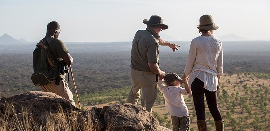 A family enjoys the views on a walking safari in Kenya