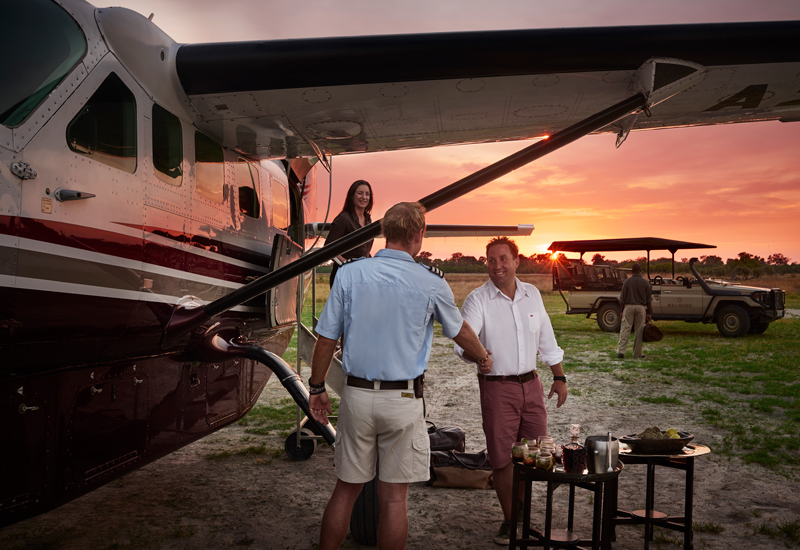 pilot and lodge staff greeting guests on arrival. 