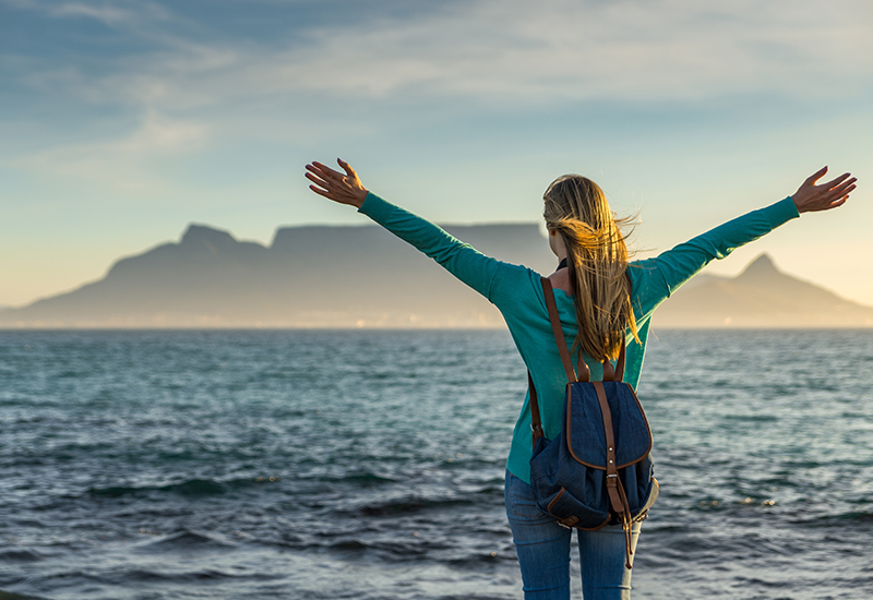  woman-standing-on-the-beach-in-front-of-table-mountain