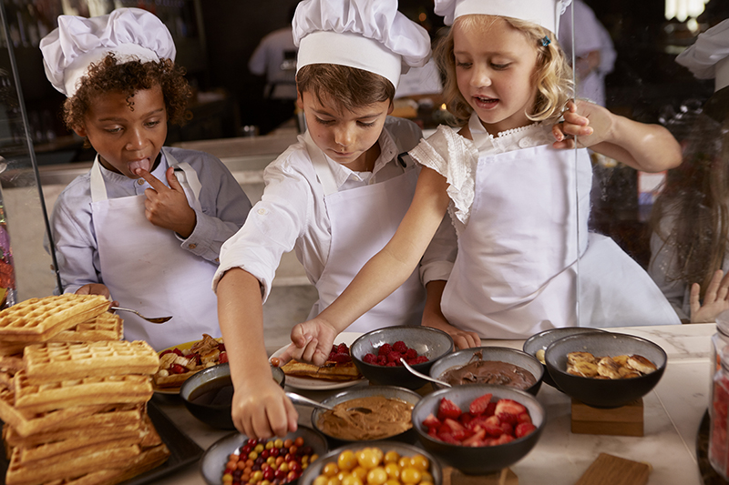 Kids enjoying their baking lesson with the pastry chef 